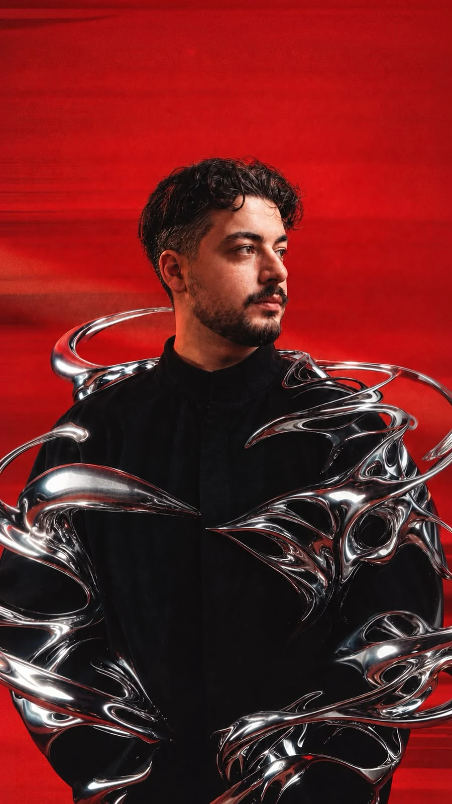 Fırat Gürel — artist portrait in chrome silver and red light
